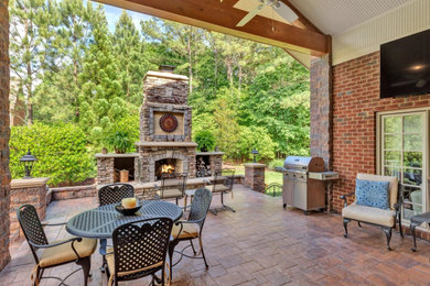 Inspiration for a large rustic conservatory in Richmond with a standard fireplace, a stone fireplace surround and multi-coloured floors.