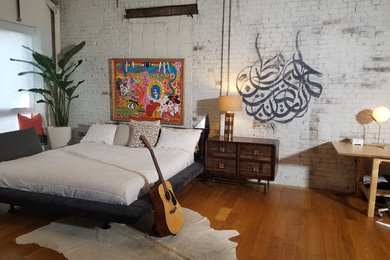Design ideas for a large eclectic master bedroom in New York with medium hardwood floors.