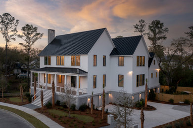 Transitional white three-story exterior home photo in Charleston with a metal roof and a black roof