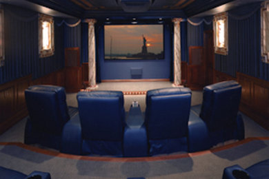 Enclosed carpeted home theater photo in Cincinnati with blue walls and a projector screen