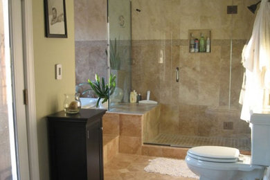 Example of a mid-sized classic beige tile and ceramic tile bathroom design in Houston with a vessel sink, raised-panel cabinets, medium tone wood cabinets and granite countertops