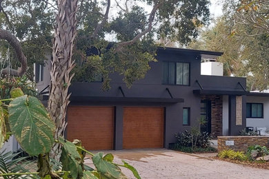 Garage - mid-century modern garage idea in Other