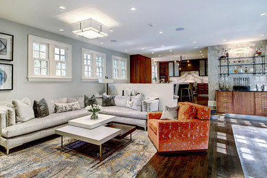 Example of a mid-sized trendy dark wood floor and wallpaper living room design in Denver with a bar and gray walls