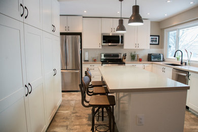 Kitchen - transitional kitchen idea in Toronto with white cabinets and white backsplash