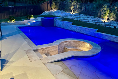 Inspiration for a large transitional backyard stone and rectangular pool fountain remodel in Austin