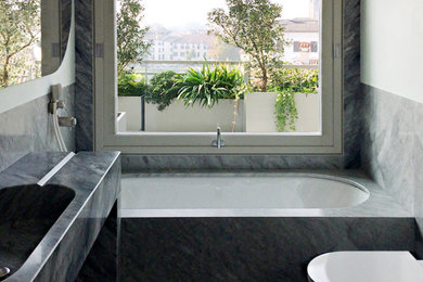 Inspiration for a modern powder room in Other with marble floors, a trough sink, marble and marble benchtops.