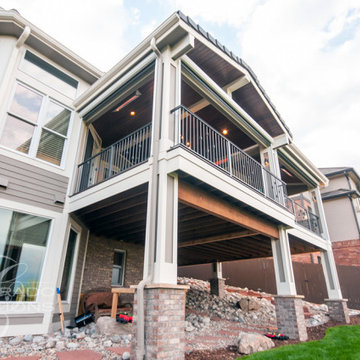 Luxury Outdoor Living Deck with Kitchen, Fireplace, and Bar Seating