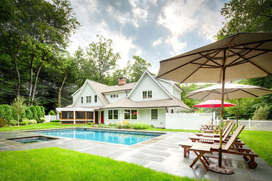 Inspiration for a large timeless backyard rectangular and stone lap hot tub remodel in New York