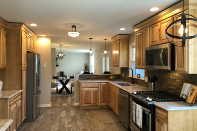 Large mountain style ceramic tile kitchen photo in Philadelphia with an undermount sink, light wood cabinets, granite countertops, stone tile backsplash and stainless steel appliances