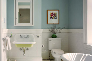Traditional kids bathroom in Philadelphia with a claw-foot tub, subway tile, a wall-mount sink and blue walls.