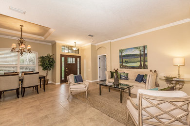 Huge trendy open concept porcelain tile and beige floor living room photo in Tampa with beige walls