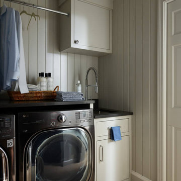 Laundry Room with Sink, Black Appliances, and Shiplap Walls