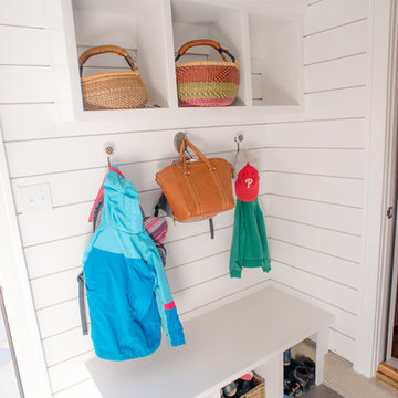 Mudroom entry with built-in storage and boot bench