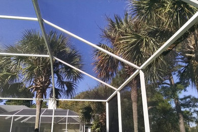 Patio - large tropical backyard patio idea in Miami