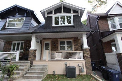 Example of a mid-sized transitional multicolored two-story mixed siding exterior home design in Toronto with a shingle roof