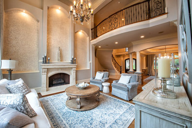 This is an example of an expansive formal open concept living room in Raleigh with grey walls, dark hardwood floors, a standard fireplace, a stone fireplace surround and brown floor.