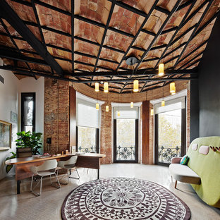 Photo of a large industrial home studio in Barcelona with white walls, a freestanding desk, travertine floors and no fireplace.