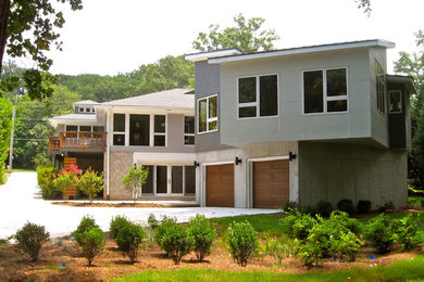 Large trendy gray two-story vinyl flat roof photo in Atlanta