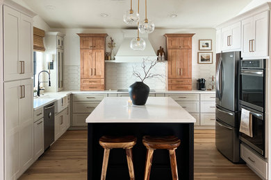 Example of a large transitional u-shaped brown floor eat-in kitchen design in Phoenix with an undermount sink, shaker cabinets, gray cabinets, quartz countertops, white backsplash, subway tile backsplash, stainless steel appliances, an island and white countertops