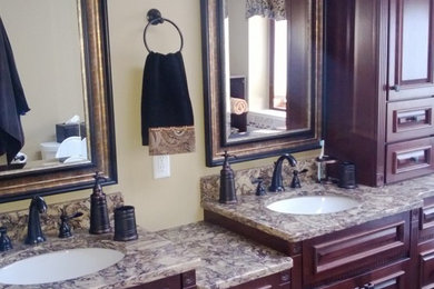 Inspiration for a large timeless master ceramic tile bathroom remodel in Other with beaded inset cabinets, dark wood cabinets, granite countertops, beige walls and an undermount sink