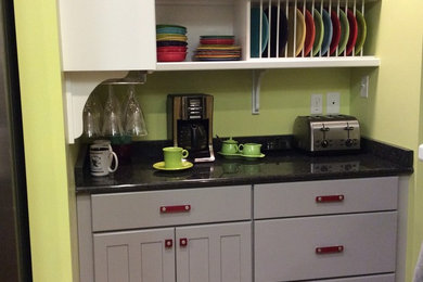 Mid-sized eclectic galley medium tone wood floor eat-in kitchen photo in Other with shaker cabinets, gray cabinets, granite countertops, metallic backsplash, metal backsplash, stainless steel appliances and an island