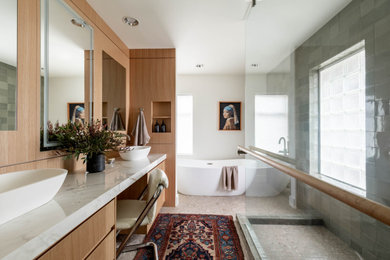 Example of a mid-sized trendy master green tile and ceramic tile terrazzo floor, beige floor and double-sink bathroom design in Seattle with flat-panel cabinets, light wood cabinets, a two-piece toilet, white walls, a vessel sink, quartz countertops, multicolored countertops and a floating vanity