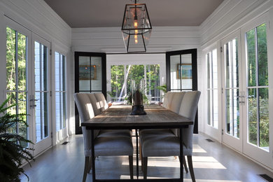Inspiration for a mid-sized country separate dining room in Chicago with white walls, light hardwood floors, no fireplace and brown floor.