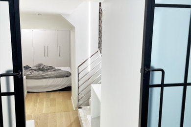 Example of a small minimalist master bedroom design in New York with white walls