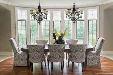Example of a large classic medium tone wood floor dining room design in Chicago with green walls