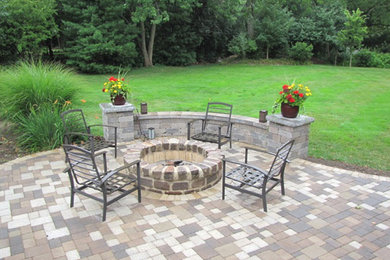Mid-sized traditional backyard patio in Chicago with a fire feature, brick pavers and no cover.