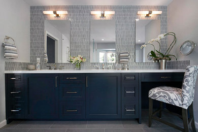 Example of a large transitional master blue tile and glass tile porcelain tile, gray floor and double-sink bathroom design in San Francisco with recessed-panel cabinets, blue cabinets, a two-piece toilet, gray walls, an undermount sink, quartz countertops, a hinged shower door, white countertops and a built-in vanity