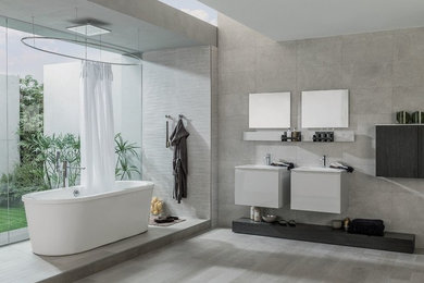 Photo of a contemporary bathroom in Hobart with a freestanding tub, black and white tile, brown tile, white tile and a console sink.