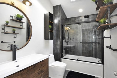Example of a single-sink sliding shower door design in Boston with a freestanding vanity