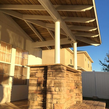 Outdoor Bar with Exposed Rafter Roofing & Paver Seating