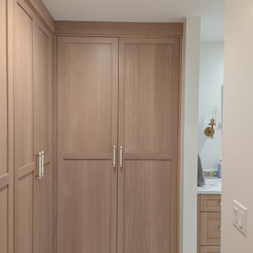 Amish Frameless White oak primary bath and closet with painted vanity