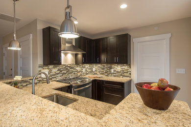 Open concept kitchen - mid-sized contemporary u-shaped light wood floor open concept kitchen idea in Boston with an undermount sink, recessed-panel cabinets, dark wood cabinets, granite countertops, multicolored backsplash, mosaic tile backsplash and stainless steel appliances