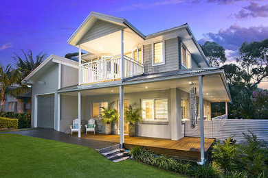 This is an example of a small beach style two-storey grey exterior in Sydney.