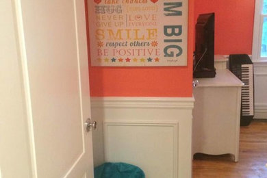 This is an example of a small modern kids' bedroom for girls in New York with orange walls.