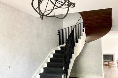 Design ideas for a large modern curved staircase in Melbourne with metal railing.