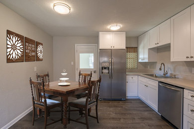 Mid-sized trendy dark wood floor eat-in kitchen photo in Denver with a drop-in sink, shaker cabinets, white cabinets, quartzite countertops and beige countertops