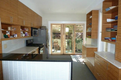 This is an example of a medium sized contemporary single-wall enclosed kitchen in Other with flat-panel cabinets, medium wood cabinets, white splashback, glass tiled splashback, stainless steel appliances, concrete flooring, a single-bowl sink, engineered stone countertops, a breakfast bar and grey floors.
