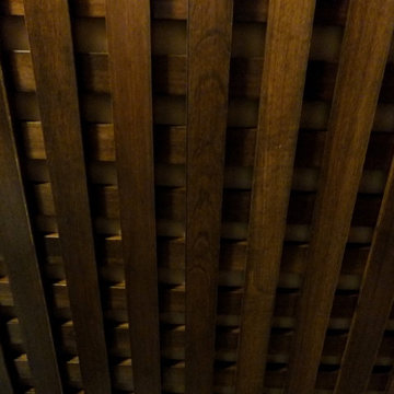 Latticed walnut strips on ceiling create an impressive look