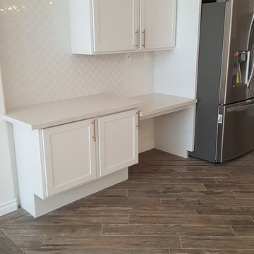 Open desk area with adjacent pull-outs for cook books & baking utensils