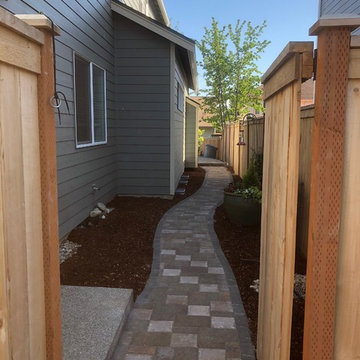 Raised holland patio and walkway with manor stone wall