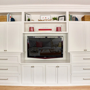 Photo of a large classic enclosed home cinema in Providence with beige walls, light hardwood flooring, a built-in media unit and beige floors.