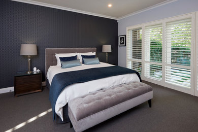 Example of a mid-sized master carpeted, gray floor and wallpaper bedroom design in Melbourne with blue walls