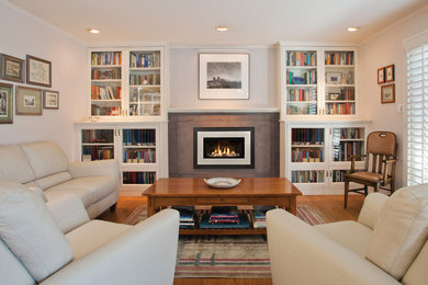 Photo of a mid-sized transitional formal enclosed living room in Portland with white walls, dark hardwood floors, a standard fireplace, a concrete fireplace surround and no tv.