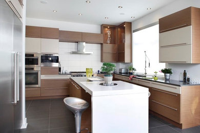 Large minimalist l-shaped ceramic tile eat-in kitchen photo in Montreal with an undermount sink, flat-panel cabinets, medium tone wood cabinets, quartz countertops, white backsplash, ceramic backsplash, stainless steel appliances and an island