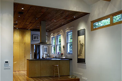 Arts and crafts open concept medium tone wood floor family room photo in Houston with white walls