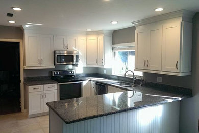 Mid-sized transitional u-shaped ceramic tile and beige floor eat-in kitchen photo in San Diego with a double-bowl sink, shaker cabinets, white cabinets, granite countertops, gray backsplash, stainless steel appliances, a peninsula and gray countertops